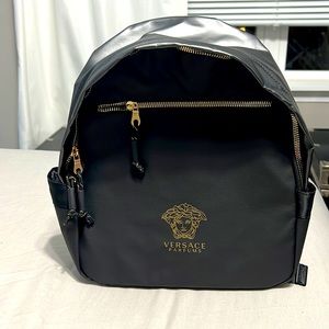 Black and gold Versace Parfums backpack